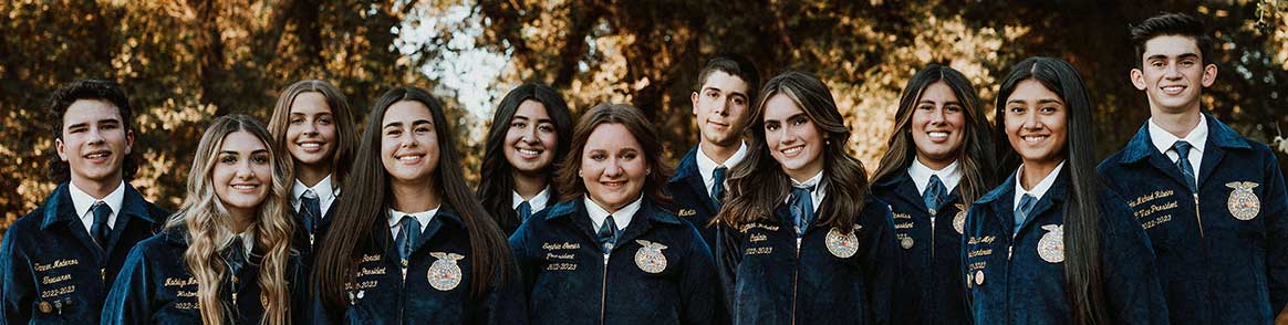 Tulare FFA 2022-2023 Officers posing for a group picture in their blue jackets