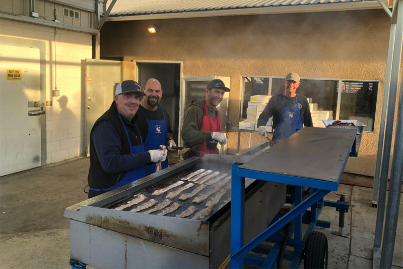 Booster club members cooking bacon