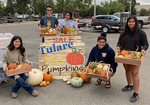 Students selling pumpkins