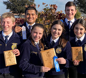 six FFA students with ribbons and plaques
