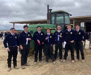 Students in front of tractor with ribbons
