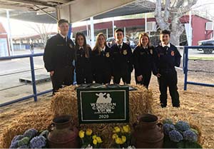 FFA students with hay bale